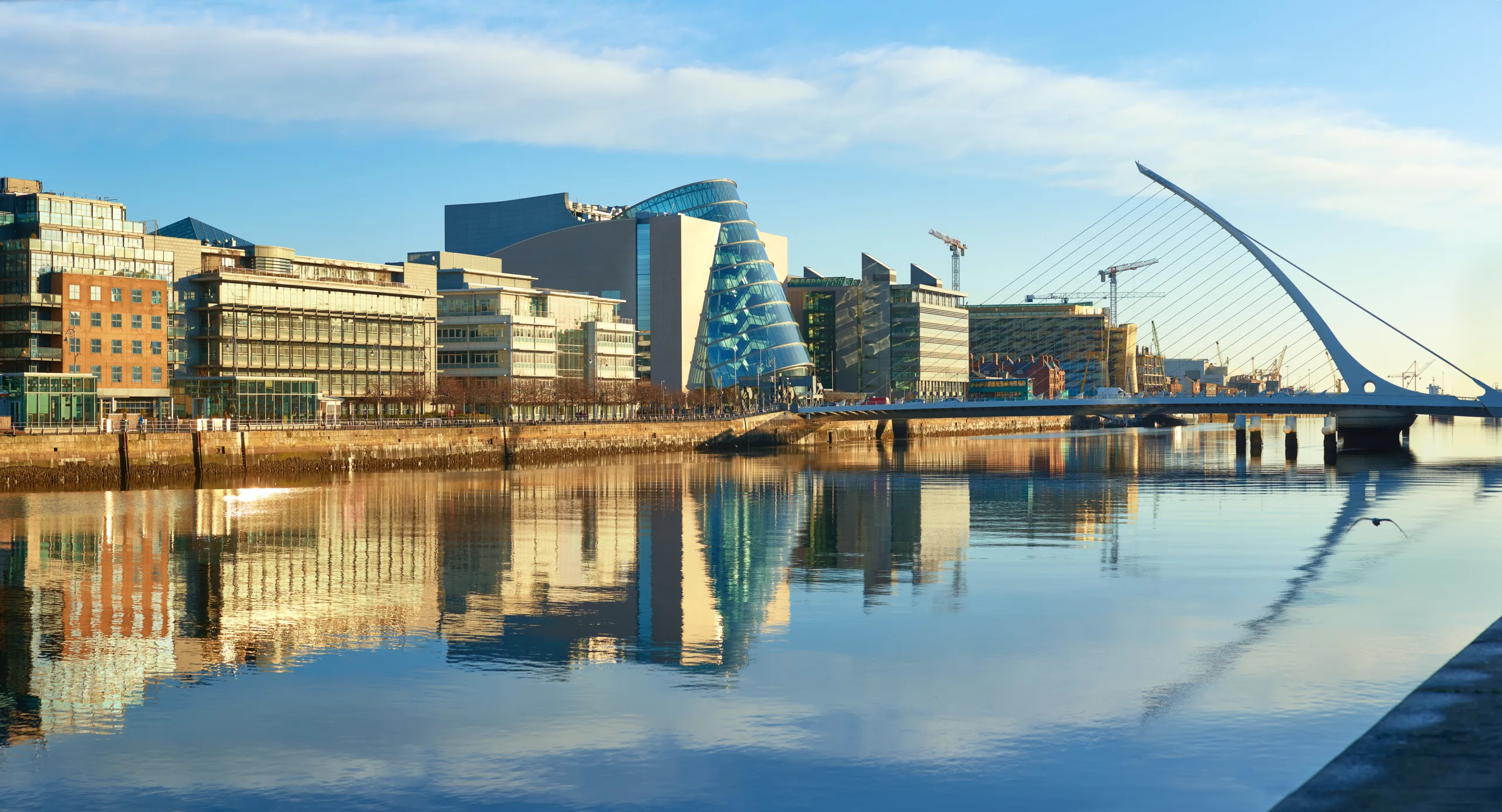 Modern buildings and the Samuel Beckett Bridge on the Liffey river, Dublin