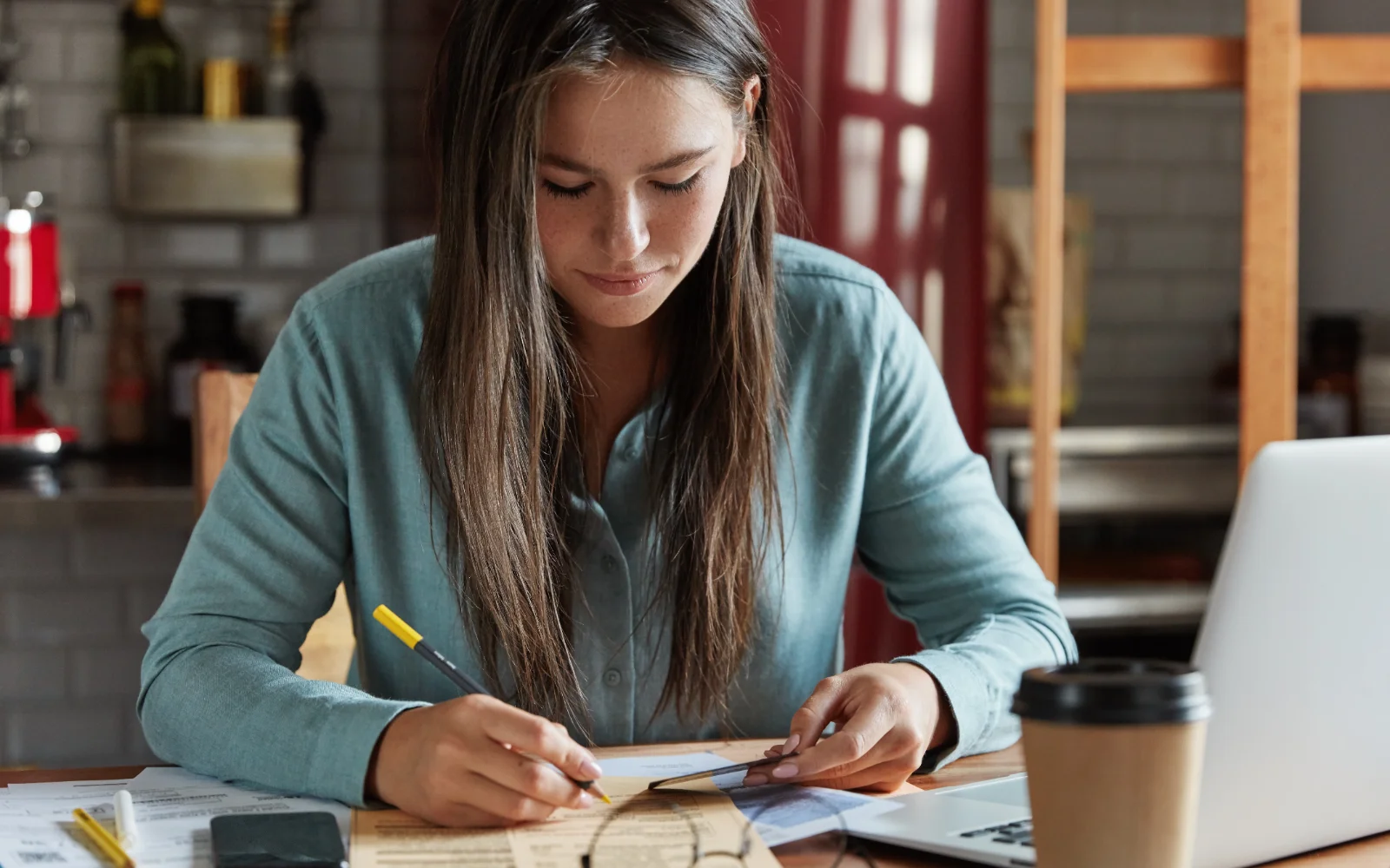 Documents, laptop and phone on a desk — paperwork for opening a bank account in Ireland